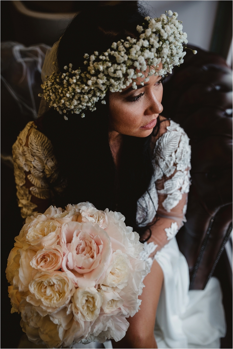 photo of the bride facing the light with large flower crown at surrey county hall wedding london photography